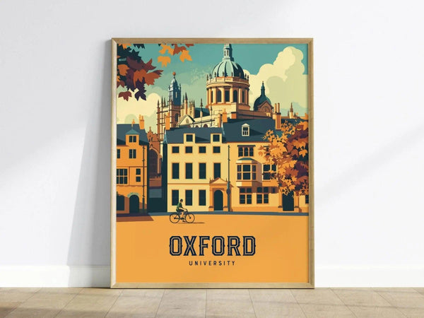 Framed poster depicting Oxford Universitys iconic architecture with spires and a cyclist in the foreground, set against an autumnal backdrop. The bold text Oxford University is featured prominently.