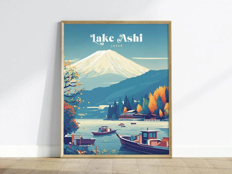 A vibrant poster of Lake Ashi in Japan features a serene view of Mount Fuji in the background, surrounded by colorful autumn trees. The calm lake reflects the landscape, with boats gently floating on the water, creating a tranquil scene.