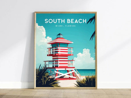 This poster features a vibrant illustration of a red and white lifeguard tower on South Beach, Miami. The scene includes turquoise waters, a clear sky with fluffy clouds, and palm fronds, encapsulating a tropical beach vibe.