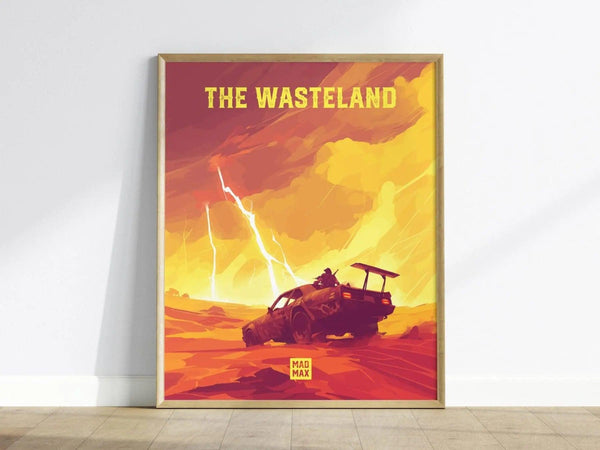 A framed poster titled The Wasteland depicts a post-apocalyptic scene with a rugged vehicle and figure against a dramatic yellow and orange sky with lightning. The artwork has a bold, graphic style and is set against a light wall.