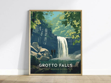 Framed artwork depicting a serene waterfall in a lush forest setting, with two small figures standing by the water. The poster reads Grotto Falls, Great Smoky Mountains National Park.