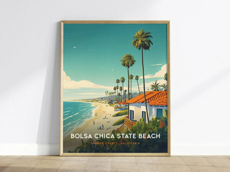 A framed poster of Bolsa Chica State Beach features a vibrant illustration with palm trees, sandy beach, ocean waves, and coastal homes under a bright blue sky.