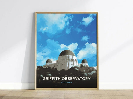 A framed poster of Griffith Observatory shows its domes against a vibrant blue sky with clouds, emphasizing its architectural beauty. The text Griffith Observatory California is displayed below.