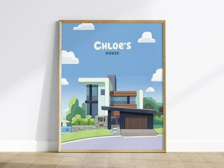 A framed poster of Chloes House features a modern architectural design set against a bright blue sky with fluffy white clouds.