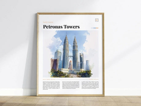 Framed poster of the Petronas Towers displayed against a white wall. The artwork features a watercolor-style depiction of Kuala Lumpurs skyline, highlighting the iconic towers under a blue sky.