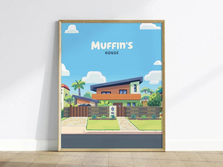 Framed poster of a colorful house with a modern design, surrounded by greenery, under a bright blue sky. The text Muffins House is displayed at the top.