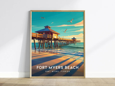 A framed poster of Fort Myers Beach depicts a vibrant pier extending over calm waters, with seagulls flying above. The text reads Fort Myers Beach, Fort Myers, Florida.