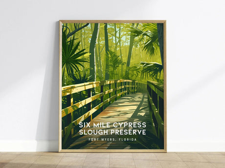 A framed poster of Six Mile Cypress Slough Preserve features a wooden boardwalk amidst lush green foliage and towering trees. Text reads Six Mile Cypress Slough Preserve, Fort Myers, Florida.