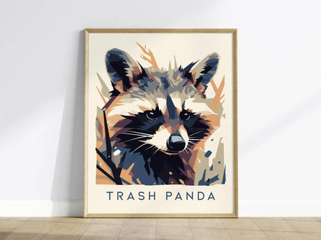 A framed poster features a stylized raccoon in a modern vector art style with Trash Panda written below. The design uses abstract shapes and bold colors for a striking effect.