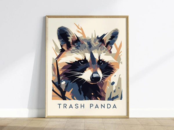 A framed poster features a stylized raccoon in a modern vector art style with Trash Panda written below. The design uses abstract shapes and bold colors for a striking effect.