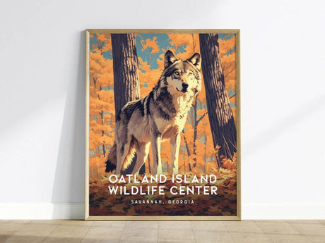 A framed poster depicting a wolf standing in a vibrant autumn forest with orange foliage. The text reads Oatland Island Wildlife Center, Savannah, Georgia.