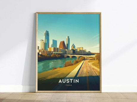 Framed artwork depicting the Austin, Texas skyline with modern buildings, a river, and a road under a clear blue sky. The text AUSTIN TEXAS is visible at the bottom.