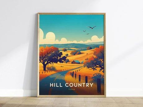 A vibrant poster titled Hill Country, Texas features a scenic landscape with rolling hills in warm autumn hues. The foreground includes a winding road, trees with orange foliage, and a small house, creating a tranquil atmosphere.