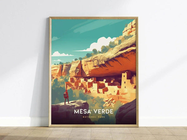 A framed poster of Mesa Verde National Park showing stylized cliff dwellings under a clear blue sky, with a person standing on a rock in the foreground.