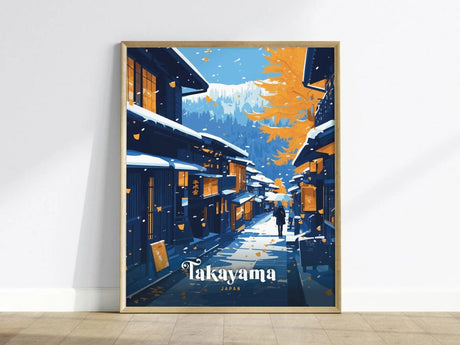 Framed poster depicting a picturesque, snow-covered street in Takayama, Japan, with traditional wooden houses and a person walking under falling leaves against a backdrop of mountains.