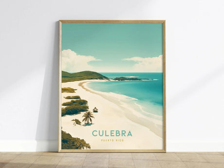 Framed poster of Culebra, Puerto Rico, depicting a serene beach with turquoise waters, lush greenery, and soft white sand, placed against a white wall.