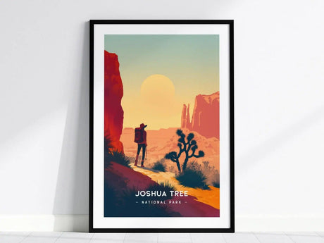A framed poster depicts a hiker with a backpack standing near a Joshua Tree, set against a colorful desert landscape with a large sun and rugged cliffs.
