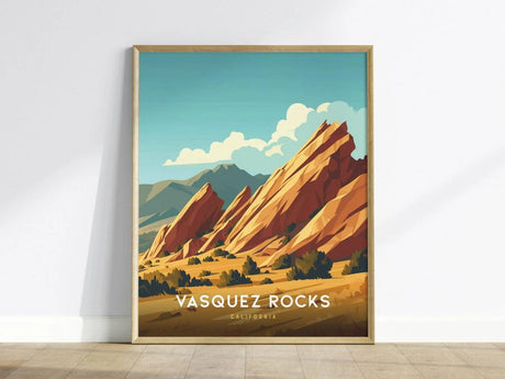 A framed poster of Vasquez Rocks features stylized, tilted sandstone formations under a blue sky with clouds. The foreground shows the text VASQUEZ ROCKS CALIFORNIA in bold letters.