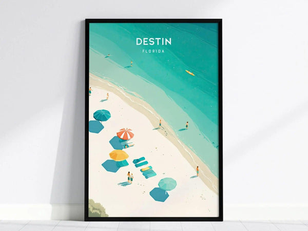 A framed poster titled Destin Florida depicts a beach scene with turquoise waters, white sand, colorful umbrellas, and sunbathers. The artwork captures a serene coastal ambiance.