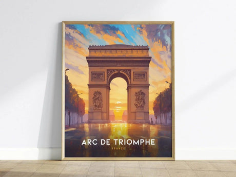 A framed poster of the Arc de Triomphe at sunrise, with vibrant skies and reflections on wet pavement, titled Arc de Triomphe France, leaning against a white wall.