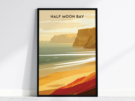 A framed poster of Half Moon Bay, California, depicting golden cliffs and a serene ocean with gentle waves under a soft sky. The artwork exudes a peaceful coastal vibe.