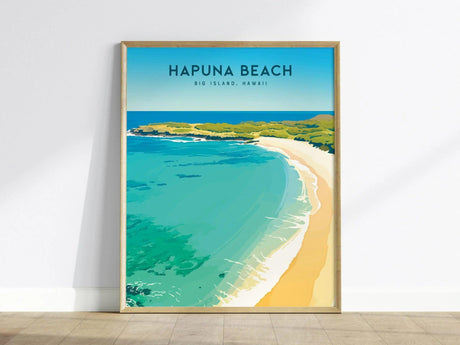 A framed poster of Hapuna Beach, Big Island, Hawaii, featuring turquoise waters, white sandy shores, and lush greenery under a clear blue sky, leaning against a white wall.