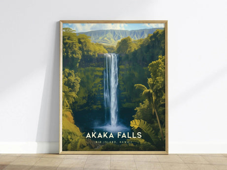 Framed poster of Akaka Falls, showcasing a waterfall cascading through lush greenery under a clear sky, leaning against a white wall on a wooden floor.