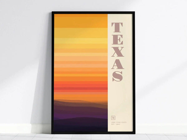 Framed poster featuring vertical abstract stripes in warm earth tones and sunset colors, with TEXAS written on the right. The design evokes the vast landscapes of the Lone Star State.