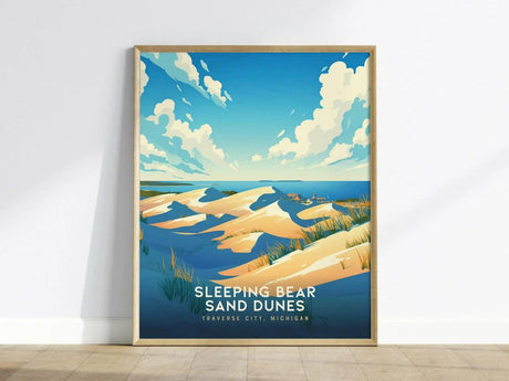 Framed poster of Sleeping Bear Sand Dunes, featuring golden sand dunes and vibrant blue skies with fluffy clouds, set against Lake Michigans waters.