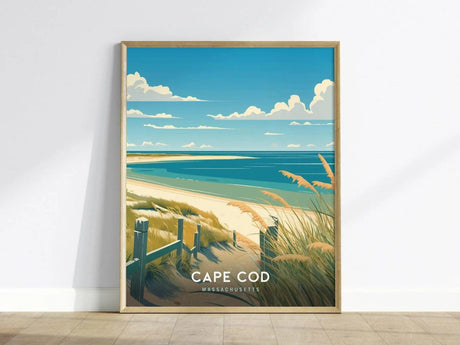 A framed poster of Cape Cod, Massachusetts, depicting a serene beach scene with soft sands, rolling dunes, and the calm Atlantic Ocean under a blue sky with clouds.