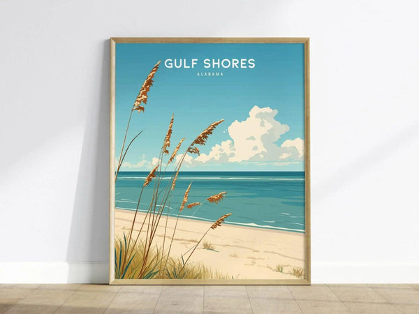 A framed poster of Gulf Shores, Alabama features a serene beach scene with soft white sand, gentle turquoise waves, and tall grasses swaying in the foreground.