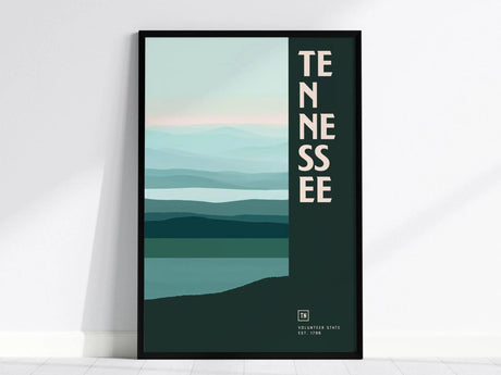 A framed poster featuring abstract horizontal lines in shades of blue and green with the word TENNESSEE vertically aligned. The design evokes a serene landscape.