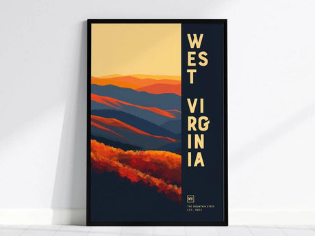 A framed poster featuring abstract mountains in shades of orange, blue, and red, with the text West Virginia vertically aligned on a dark background.