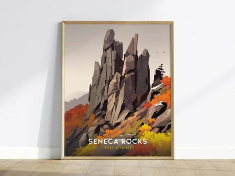 A framed poster of Seneca Rocks, depicting jagged rock formations surrounded by vibrant autumn foliage, is leaning against a white wall. The text Seneca Rocks, West Virginia is displayed below.
