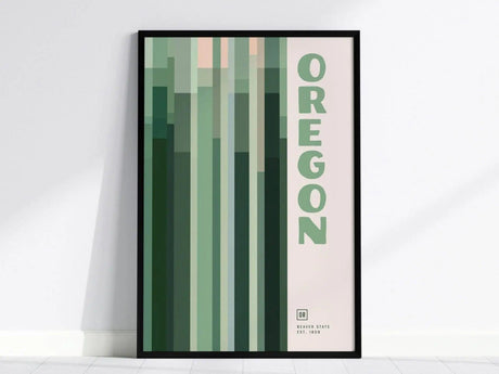 Framed minimalist poster featuring vertical green and pink geometric patterns with the word Oregon in bold letters. The design is modern and suits contemporary interiors.