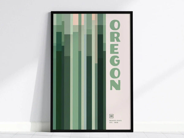 Framed minimalist poster featuring vertical green and pink geometric patterns with the word Oregon in bold letters. The design is modern and suits contemporary interiors.