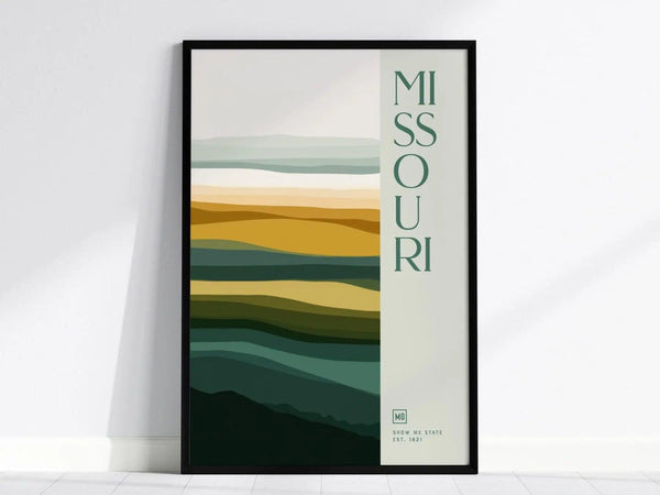 Framed Missouri poster with abstract layered color bands in green, yellow, and beige tones, featuring vertical Missouri text. Ideal for modern decor.