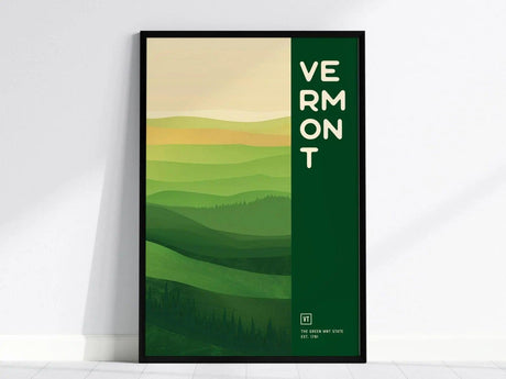 Framed poster featuring a minimalist design of rolling green hills with the word Vermont vertically aligned. The artwork captures the essence of Vermonts landscapes.