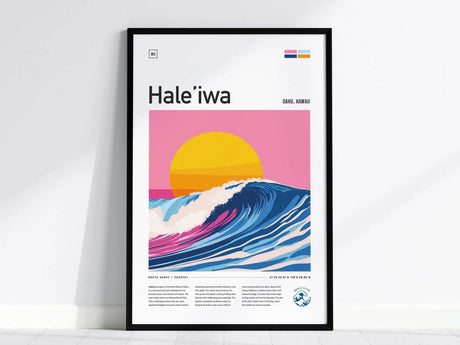 A framed poster titled Hale’iwa features a stylized wave cresting under a vibrant yellow sun against a pink sky. It includes text about North Shore, Oahu, Hawaii.