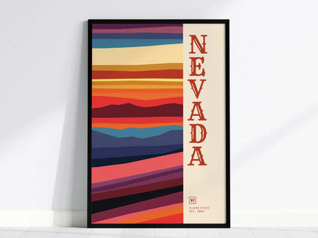 A framed Nevada State Poster features bold, colorful horizontal stripes resembling a desert landscape, with NEVADA written vertically on the right in red.