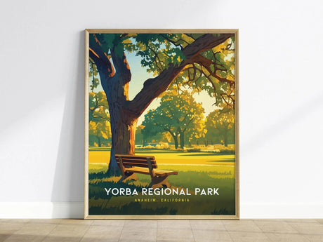 A framed poster featuring a serene park scene with a large tree and a bench, bathed in warm sunlight. The text reads Yorba Regional Park, Anaheim, California.