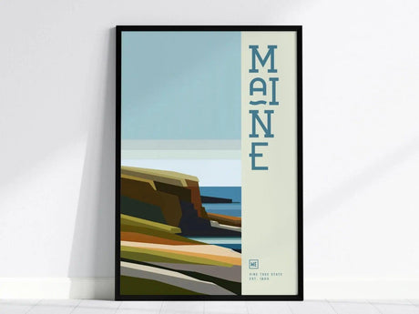Framed minimalist poster featuring abstract coastal cliffs and ocean in muted tones, with the word MAINE vertically aligned. The design is modern and geometric.