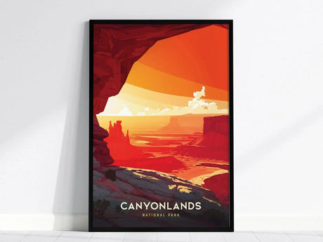 Framed poster depicting a vibrant illustration of Canyonlands National Park with red rock formations, dramatic canyons, and a bright orange and yellow sky. Text reads Canyonlands National Park.