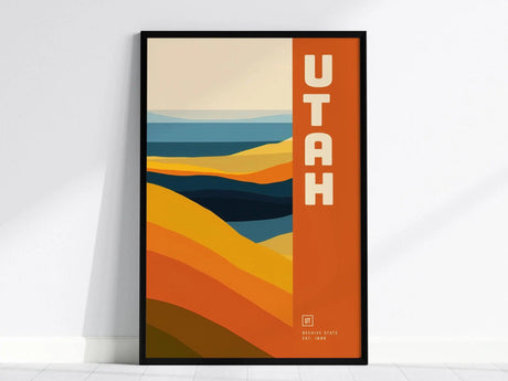 Framed minimalist poster featuring bold geometric shapes in warm desert tones of orange, yellow, and blue, with the word UTAH prominently displayed on the right.