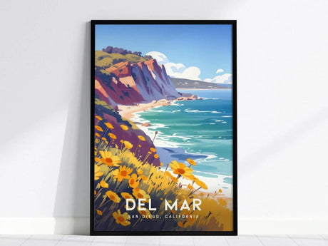 Framed poster featuring a colorful illustration of Del Mar, San Diego, with sunlit cliffs, turquoise waves, and vibrant wildflowers, leaning against a white wall.