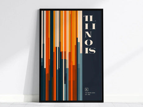 Framed Illinois poster featuring vertical stripes in warm tones and the word ILLINOIS in bold white letters on a dark background, leaning against a white wall.