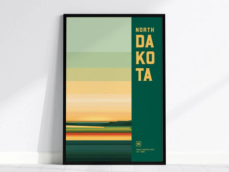 Framed North Dakota poster featuring abstract horizontal stripes in green, yellow, and orange tones with bold text on the side. Minimalist design evokes the states landscapes.