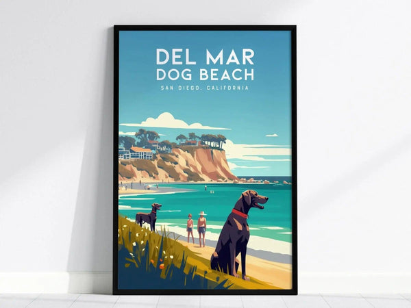 Framed poster of Del Mar Dog Beach in San Diego, featuring two dogs and people on a sunny beach with ocean waves and cliffs in the background.