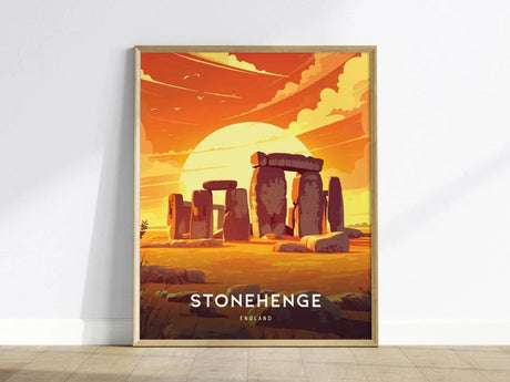 A framed poster of Stonehenge features an artistic depiction of the monument at sunset, with a vibrant orange sky and silhouetted stones. Text reads STONEHENGE ENGLAND at the bottom.