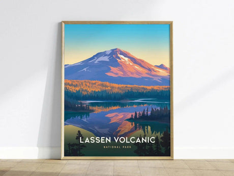 Framed poster depicting a colorful illustration of Lassen Volcanic National Park with a snow-capped mountain, dense forest, and a reflective lake under a vibrant sky.
